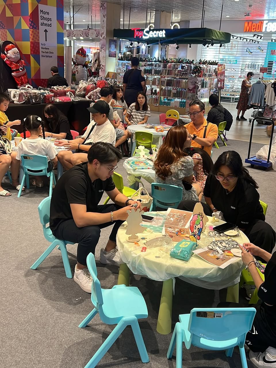 Children laughing and playing on a bouncy castle at a family event